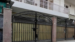 A gated entrance with a metal gate and a balcony above. - Classic With Balcony Huda Market Sector 46 (Gurugram)