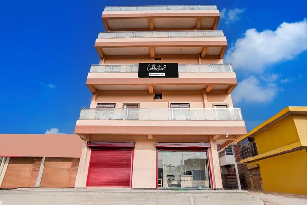 A multi-story building with a sign reading 'Collection & Company Service.' - Deluxe Super Collection O Salori (Chandpur)