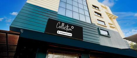 A building with a sign that reads 'Collection Company-Serviced.'