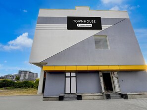 A modern building with a sign reading 'TOWNHOUSE Company Serviced.'