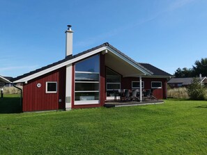 A red building with a large glass window, a chimney, and a number '33' on the side. - 4 Star Holiday Home in Grossenbrode (Grossenbrode)