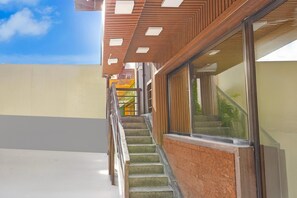 A staircase leading to a building with a wooden facade and large windows. - Classic With Twin Bed Super Hotel O Bellandur Bangalore (Bengaluru)