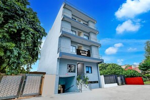 A multi-story hotel with a sign reading 'HOTEL' and balconies. - Classic With Balcony O DLF Phase 1 (Gurugram)