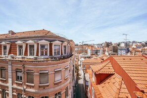 A cityscape with a prominent curved building with balconies and a red-tiled roof. - Lisbon Apartment With Picturesque City Views (Portimão)