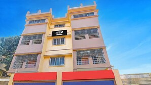 A multi-story hotel with a prominent sign, large windows, and a red awning. - Classic With Balcony Diamond Inn (Durgapur)