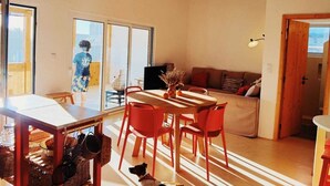 An interior with a dining area, a sofa, and a dog. - Duck House (Comporta)