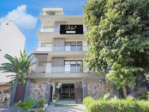 A multi-story building with a sign indicating it is a company service. - Super Collection O Sector 108 Noida (Noida)