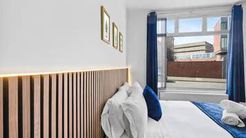 Deluxe Studio Suite | Laptop workspace, iron/ironing board