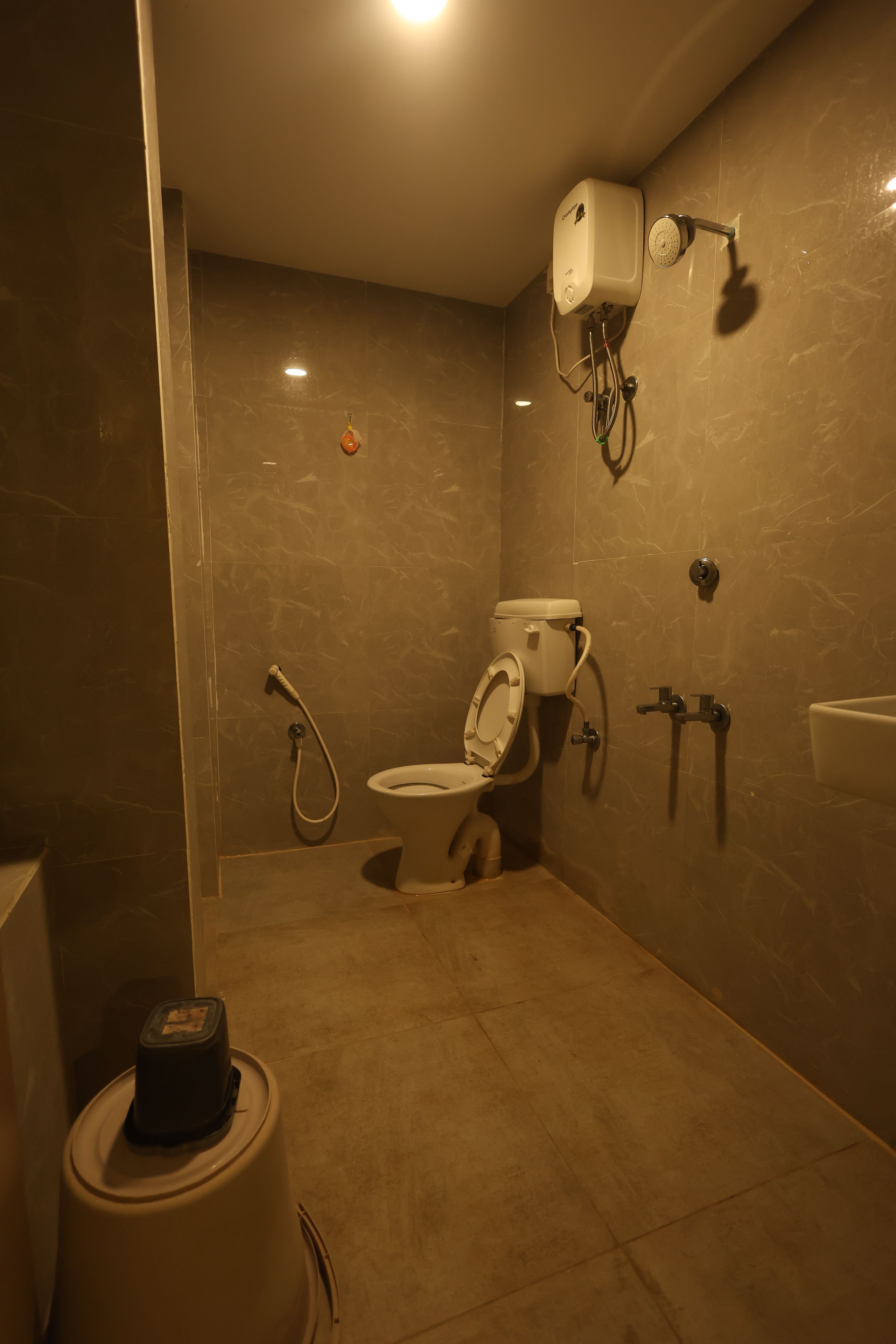 A bathroom with a toilet, bidet, and shower.