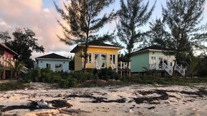 A beachfront property with multiple houses, sandy beach, and trees. - Cozy 1-bedroom bungalow in charming Pleasant Harbour, Morgan’s Bluff with AC (Morgan’s Bluff)