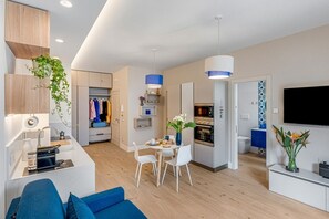 A modern apartment with a kitchen, dining area, and living room. - A Cozy Stay with Terrace in the Heart of Sorrento (Sorrento)