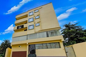 A multi-story building with balconies, a sign indicating a collection point, and a palm tree in the background. - Classic With Balcony Mourigram Near Andul Road (Howrah)