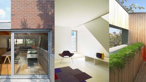 Un intérieur moderne comprenant un coin repas, un petit espace salon avec un fauteuil et une bibliothèque.