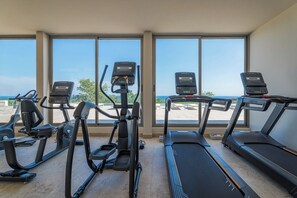 A gym with treadmills and elliptical machines, large windows with a view of the beach. - Cabo Retreat w/ Private Pool & Sea Views (Cabo San Lucas)
