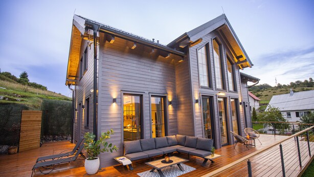 A modern house with a deck, a large window, and a sofa. - Holiday House Gorski kotar / Silver House Mrkopalj (Mrkopalj)
