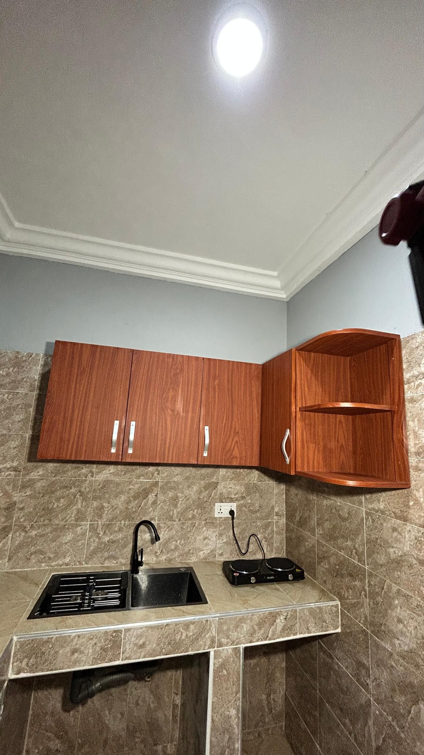 A kitchen with a built-in stove, a sink, and a countertop.