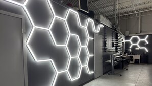 A modern interior with hexagonal light patterns on the wall, a kitchenette area, and a clean, industrial design. - Production Studio - 4 Sets / 2 Offices / Light Bank / Hex Lighting  - 4k SF (West Babylon)