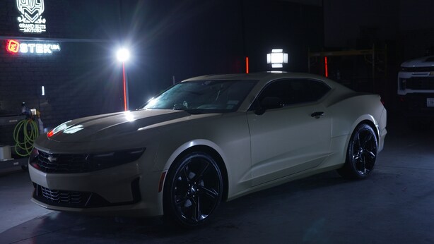 A white sports car parked in a dimly lit garage. - Production Studio - 4 Sets / 2 Offices / Light Bank / Hex Lighting  - 4k SF (West Babylon)