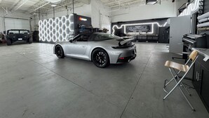 A spacious indoor garage with a silver sports car, a black SUV, and a hexagonal light installation. - Production Studio - 4 Sets / 2 Offices / Light Bank / Hex Lighting  - 4k SF (West Babylon)