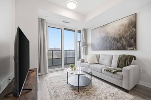 TV, table football - Contemporary Condo in DTK | Gym, Pool, & More (Kitchener)