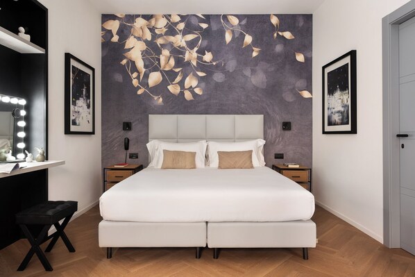 A bedroom with a bed, bedside tables, a vanity with a mirror, and wall art. - At Forty-One Apt 01 (Rome)