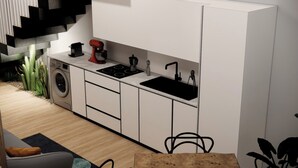 A modern kitchen with a washing machine, a red mixer, a black sink, and a stove. - Waterfront Apartment in San Leone with Sea View (San Leone)
