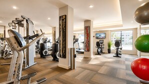A gym with cardio machines, weight equipment, and a large window providing natural light. - Chandler Vacation Rental, 2 Bedroom Condo at The Cays with a Resort Pool & Spa (Chandler)