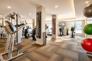 A gym with cardio machines, weight equipment, and a large window providing natural light. - Chandler Vacation Rental, 2 Bedroom Condo at The Cays with a Resort Pool & Spa (Chandler)