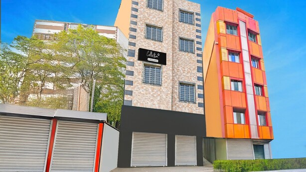 A multi-story building with a sign reading 'Collection.' - Single Room Swagatam International Airport (Barakpur)