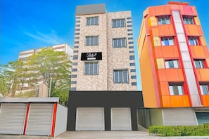 A multi-story building with a sign reading 'Collection.' - Single Room Swagatam International Airport (Barakpur)
