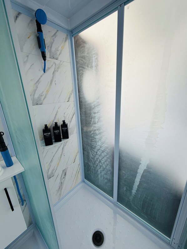 Shower, hair dryer, towels, soap