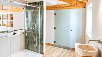 A modern bathroom with a glass-enclosed shower, a wooden ceiling, and a marble sink.