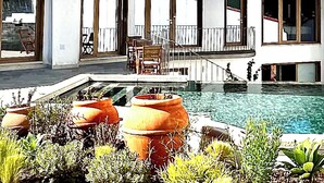 A modern house with a swimming pool, outdoor furniture, and potted plants. - &Tales Villas Collection (Óbidos)