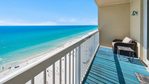 A balcony with a view of the beach and ocean. - Seychelles 1207 (Panama City Beach)