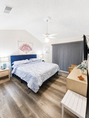 A bedroom with a bed, bedside tables, a desk, a ceiling fan, and a window with blinds. - Spacious 3-bedroom condo on 1MM in brilliant Lake Ozark with AC (Lake Ozark)
