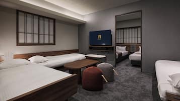 A hotel room with a large bed, a smaller bed, a desk, a chair, a sofa, and a mirror.