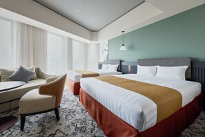 A hotel room with a bed, two armchairs, a small table, and a large window with curtains. - Premium hotel MONday MAIHAMA VIEW II (Tokyo)