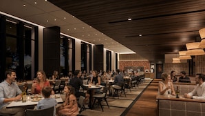 Un restaurante espacioso con varias zonas de comedor, grandes ventanales y una decoración interior moderna.