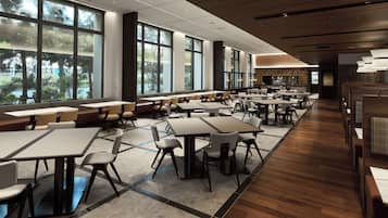 A spacious indoor dining area with multiple tables and chairs, large windows offering views of greenery, and a modern ceiling design.