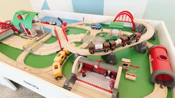 A model train layout with multiple tracks, a bridge, and various train cars.