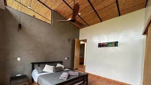 A bedroom with a bed, a nightstand, a ceiling fan, and a tiled floor. - Casa Campestre San Joaquin La Mesa (La Mesa)