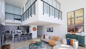 A spacious living area with a sofa, coffee table, and artwork on the wall. - Stunning Beach Front 5BD Penthouse, Spectacular Sea Views (Playa Juan Dolio)