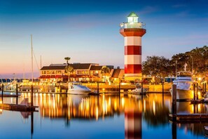 A lighthouse, marina, and waterfront buildings. - Family Sea Pines Oasis - Walk to Beach, Pool, Golf (Hilton Head Island)
