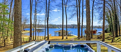 Hot Tub - Soak in the 7-person hot tub with lake views through the trees, just steps from the dock and sandy beach below.