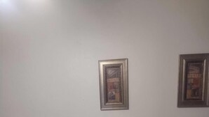 Two framed pictures on a plain wall. - Tranquil 1-bedroom house with AC in charming Tucson (Tucson)