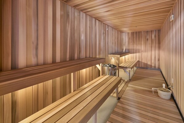 Een sauna met houten banken en een betegelde vloer.