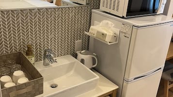 Full-size fridge, microwave, freezer, paper towels