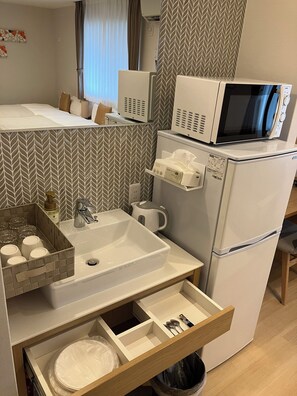 Full-size fridge, microwave, freezer, paper towels