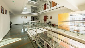 A multi-level interior with glass railings, a staircase, and a view to the outside. - Astra Hotels & Suites Marathahalli Spice (Bengaluru)