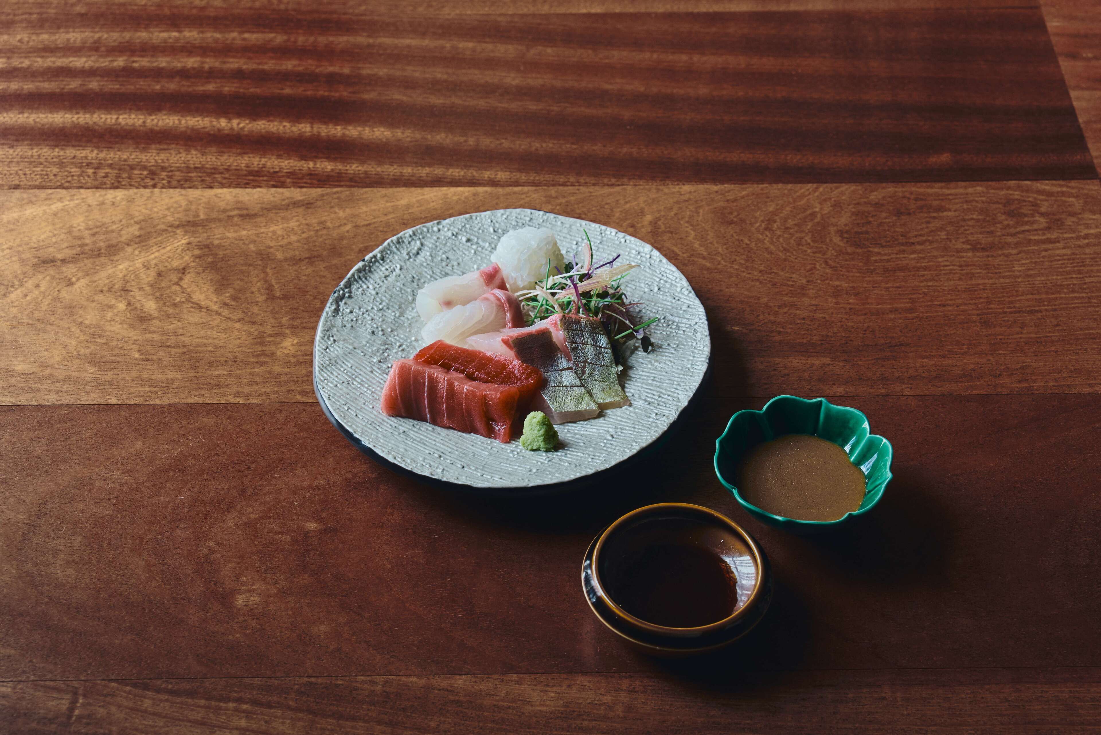A plate of sushi on a wooden table.